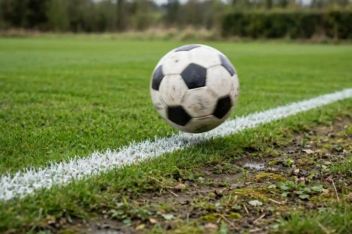 Football crossing the touchline during a match